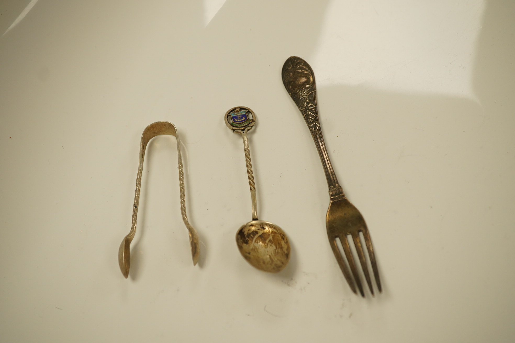 Twenty three items of mainly 19trh century silver fiddle pattern flatware, various dates and makers and a small group of assorted silver and white metal flatware, including Tiffany spoon, 39.8oz. Condition - poor to fair